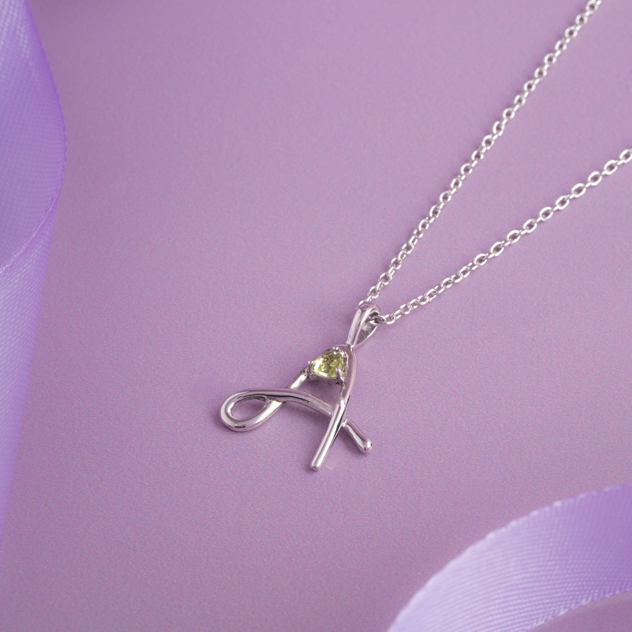 A pendant with green stone silver chain