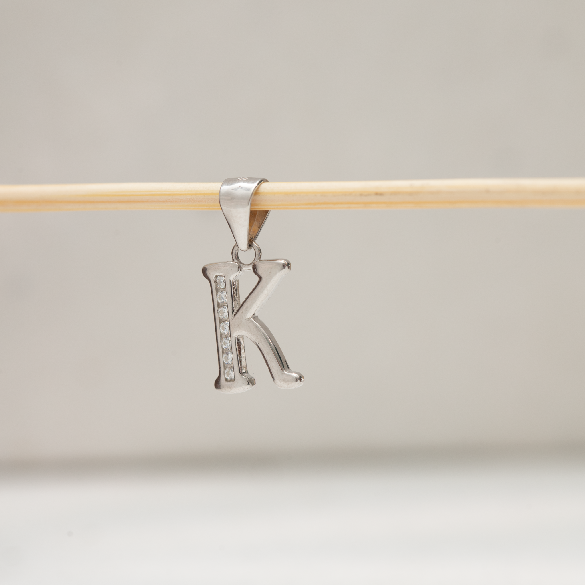 Alphabet K silver pendant with stones