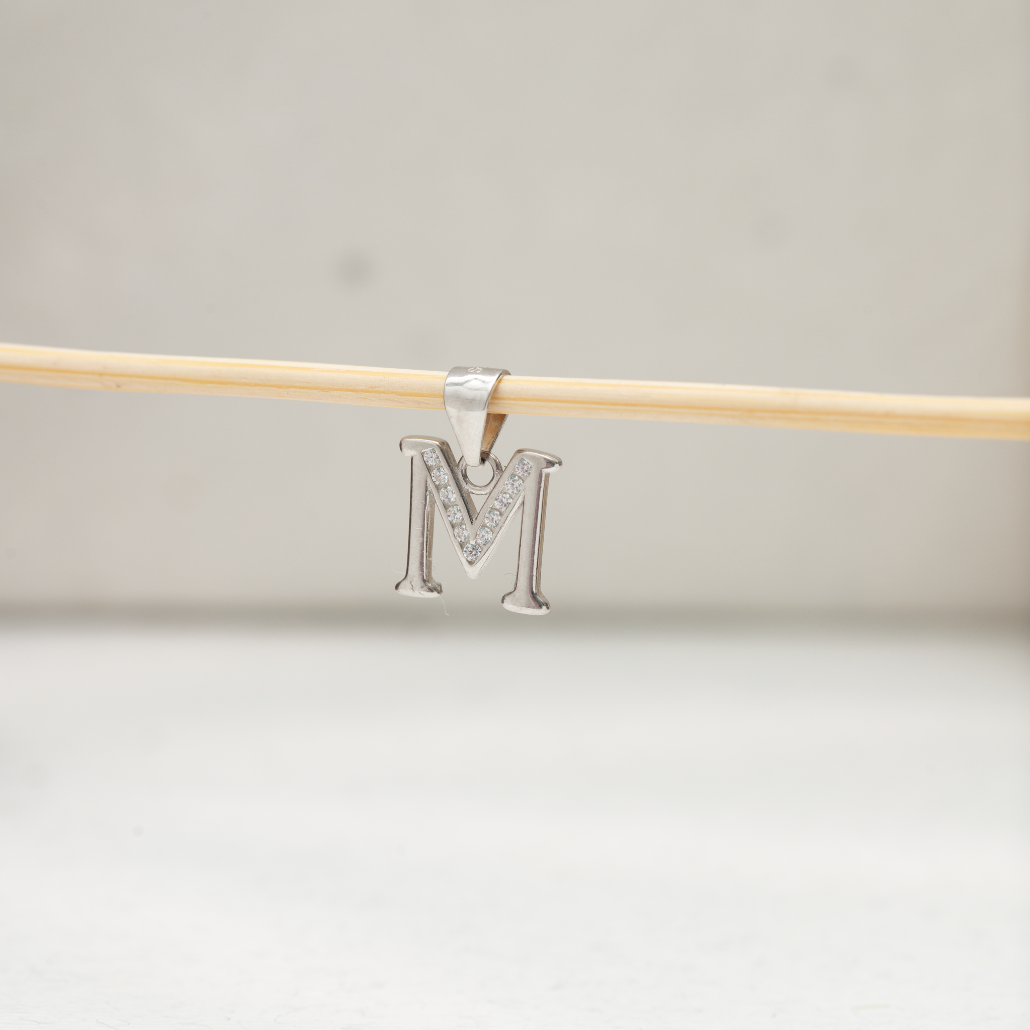 Alphabet M silver pendant with stones