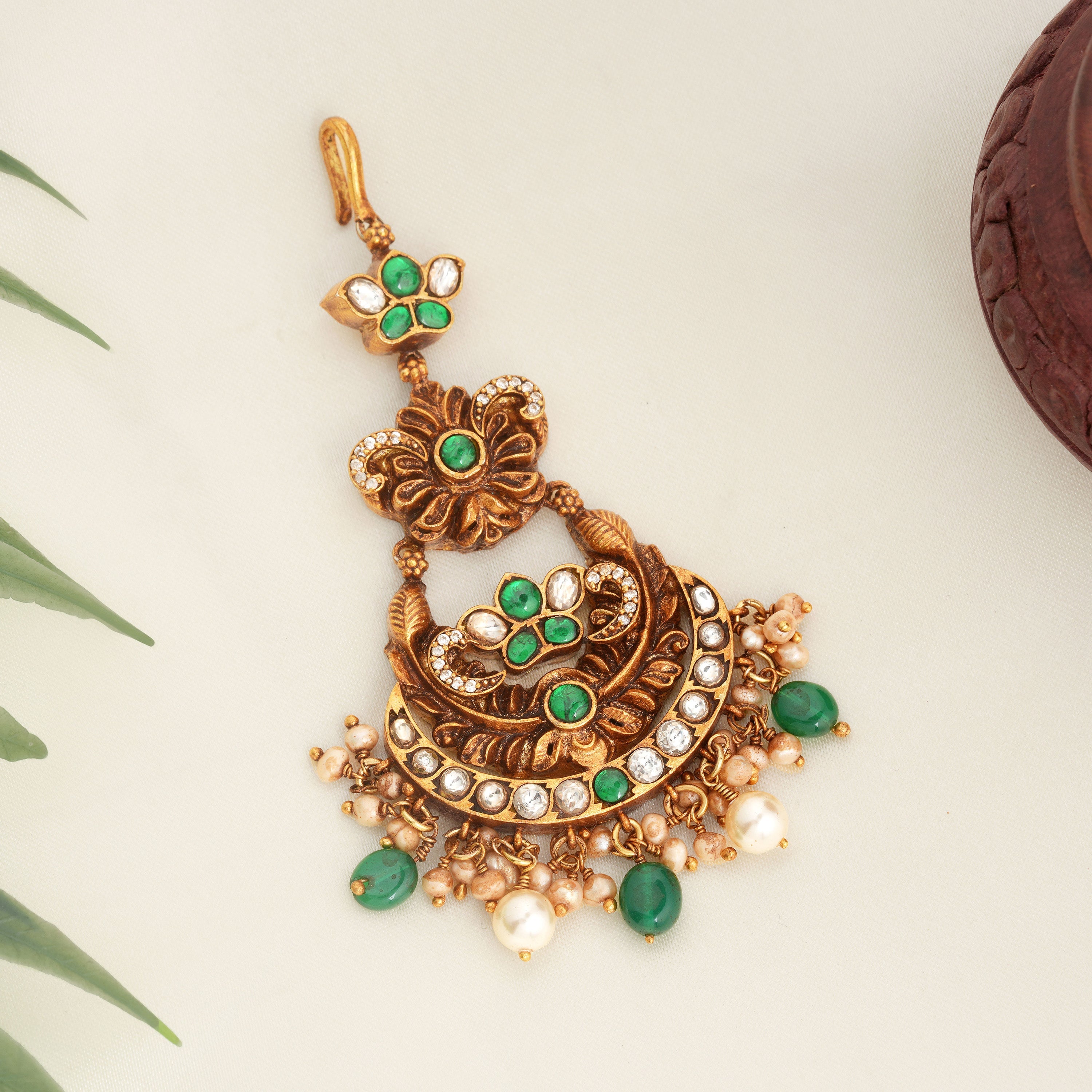 Antique gold-plated maang tikka with green stones