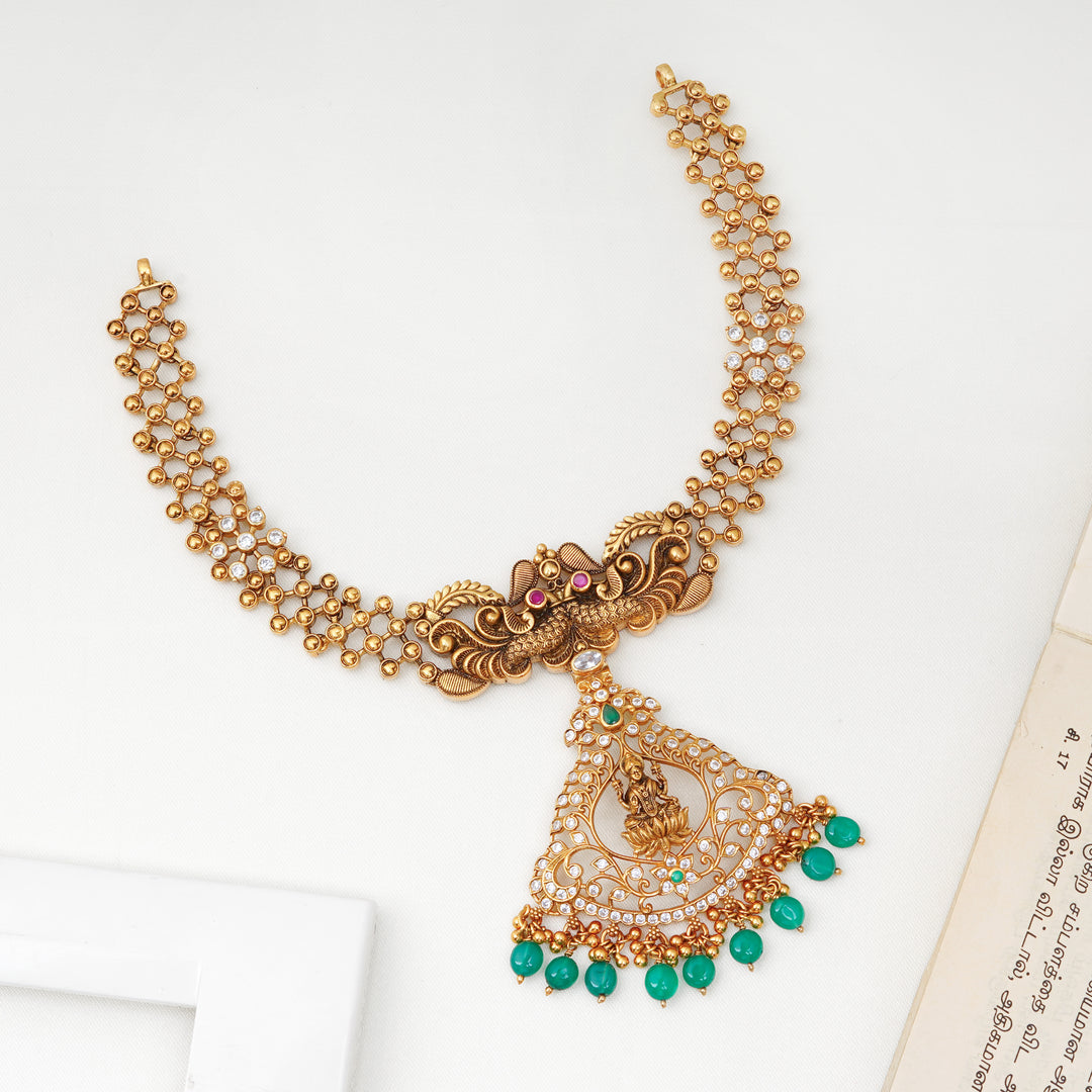 Antique gold Lakshmi pendant necklace with emerald bead hangings
