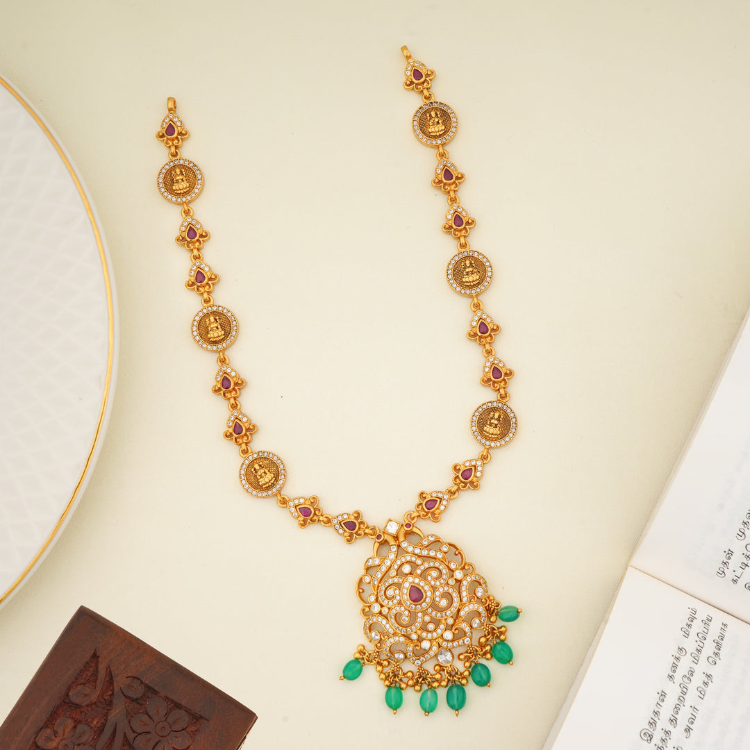 Antique gold plated temple haram with ruby stones and emerald bead drops