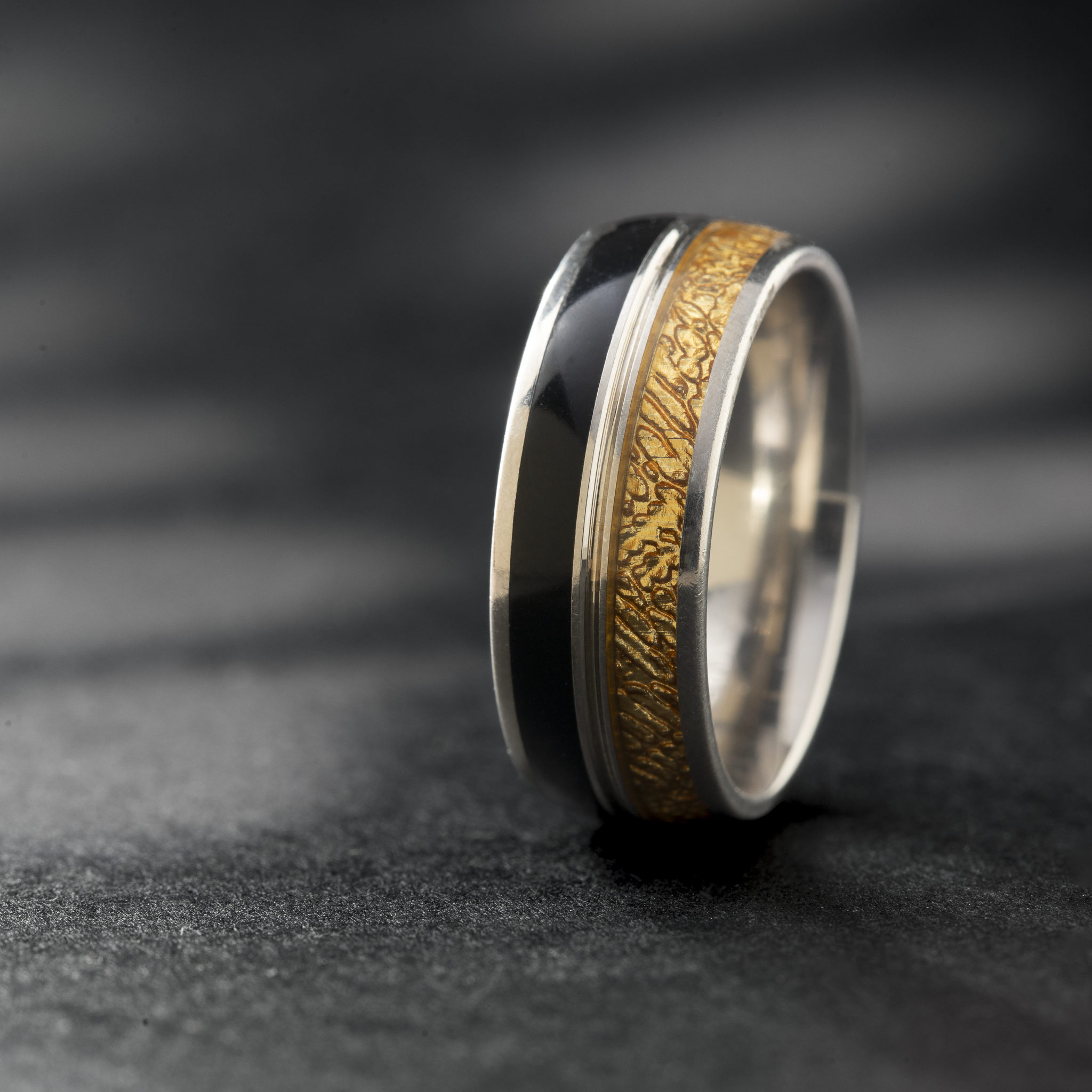 Black and gold tone silver ring