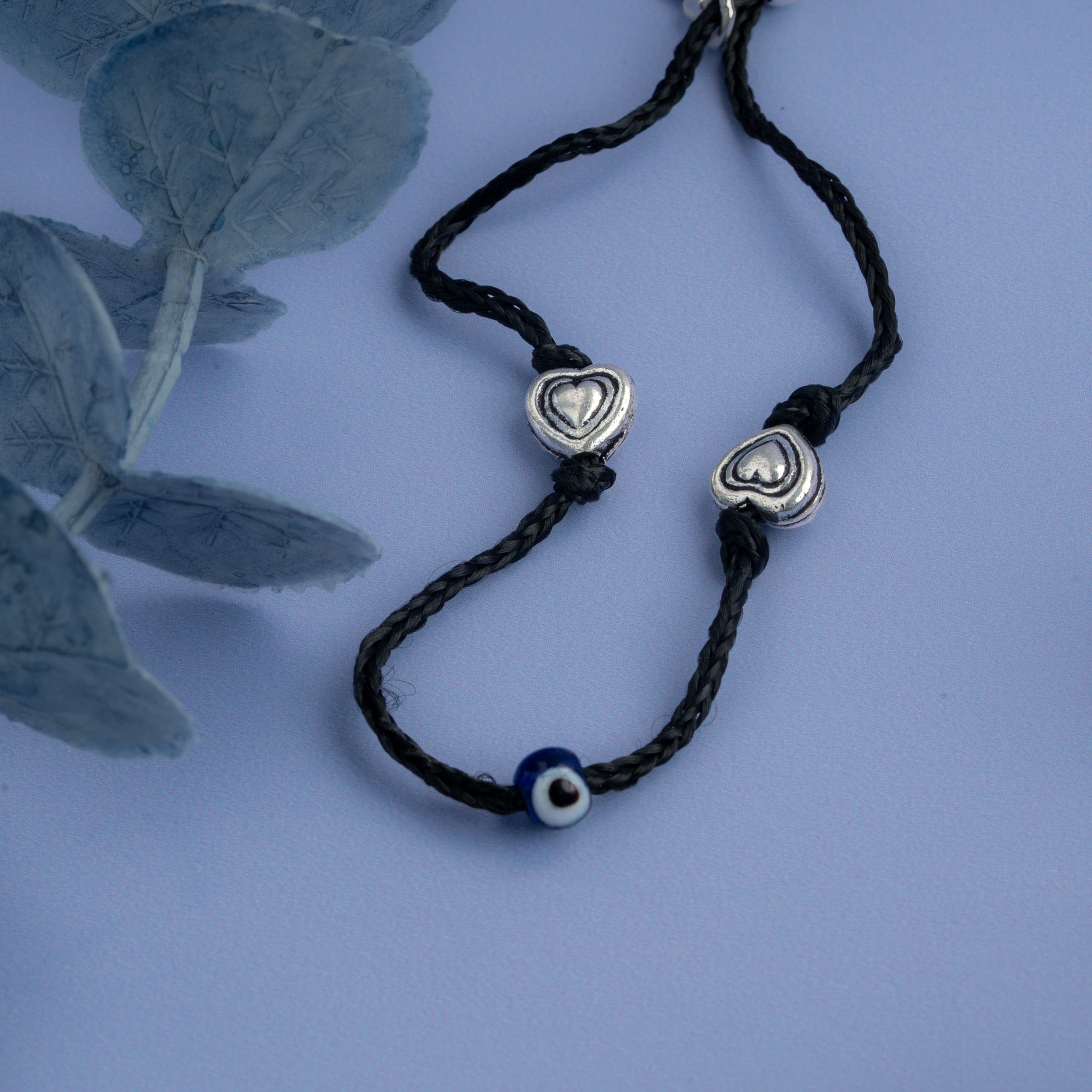 Black thread Anklet with oxidised silver heart charms and blue evil eye bead