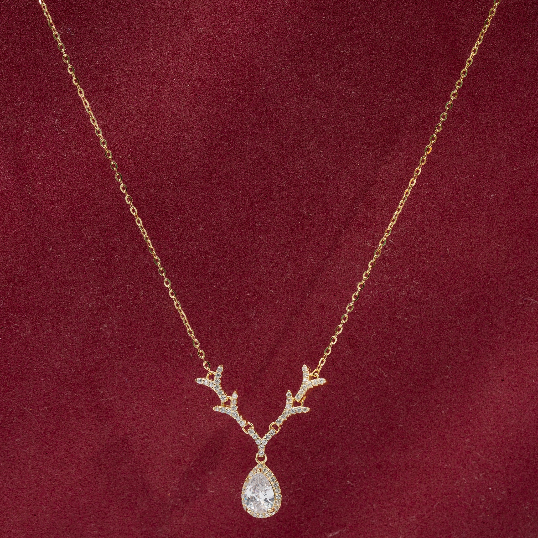Elegant gold-plated teardrop pendant with stones