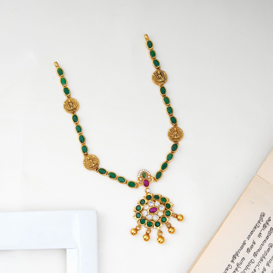 Emerald Lakshmi necklace with green stones and antique gold finish