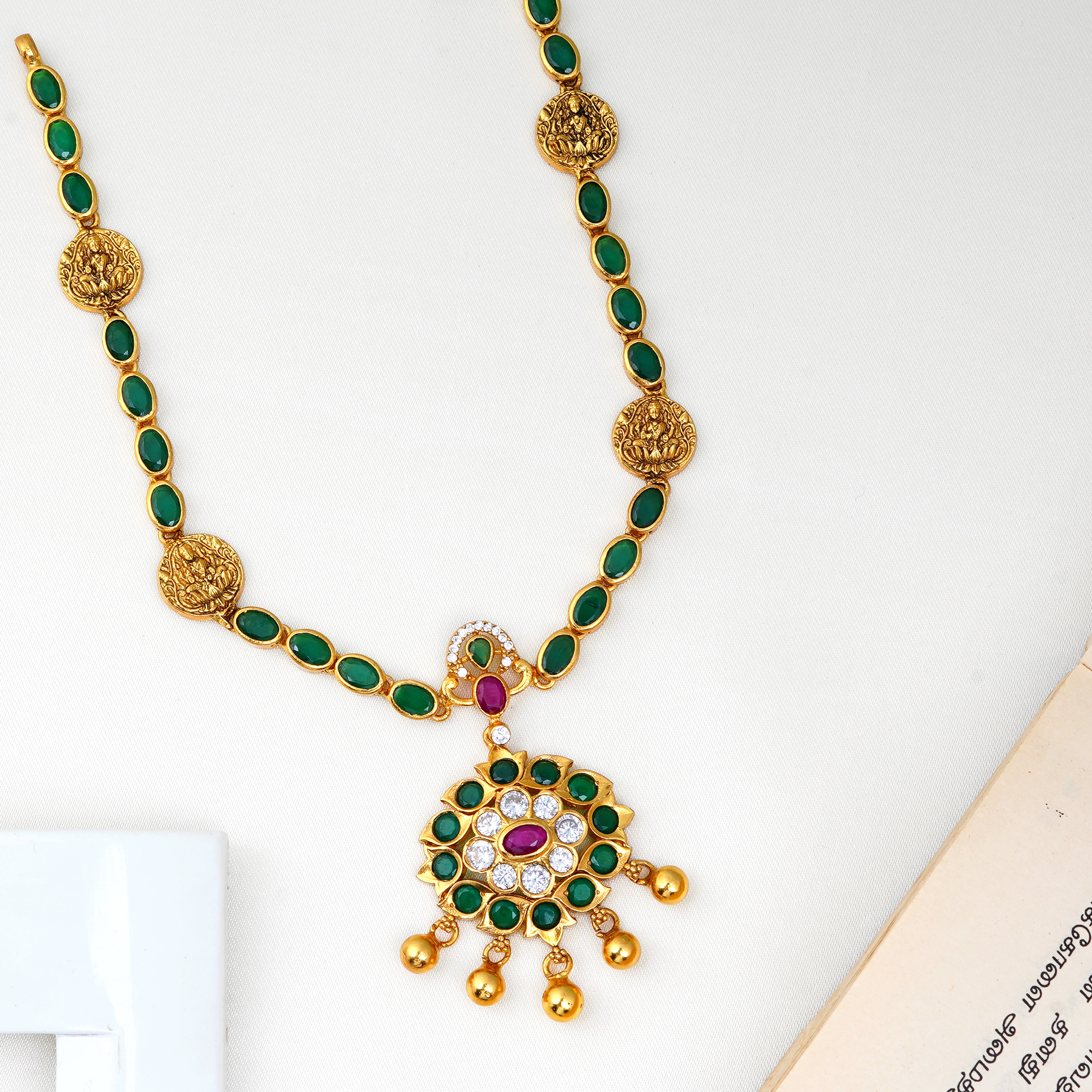 Emerald Lakshmi necklace with traditional temple design and green stones