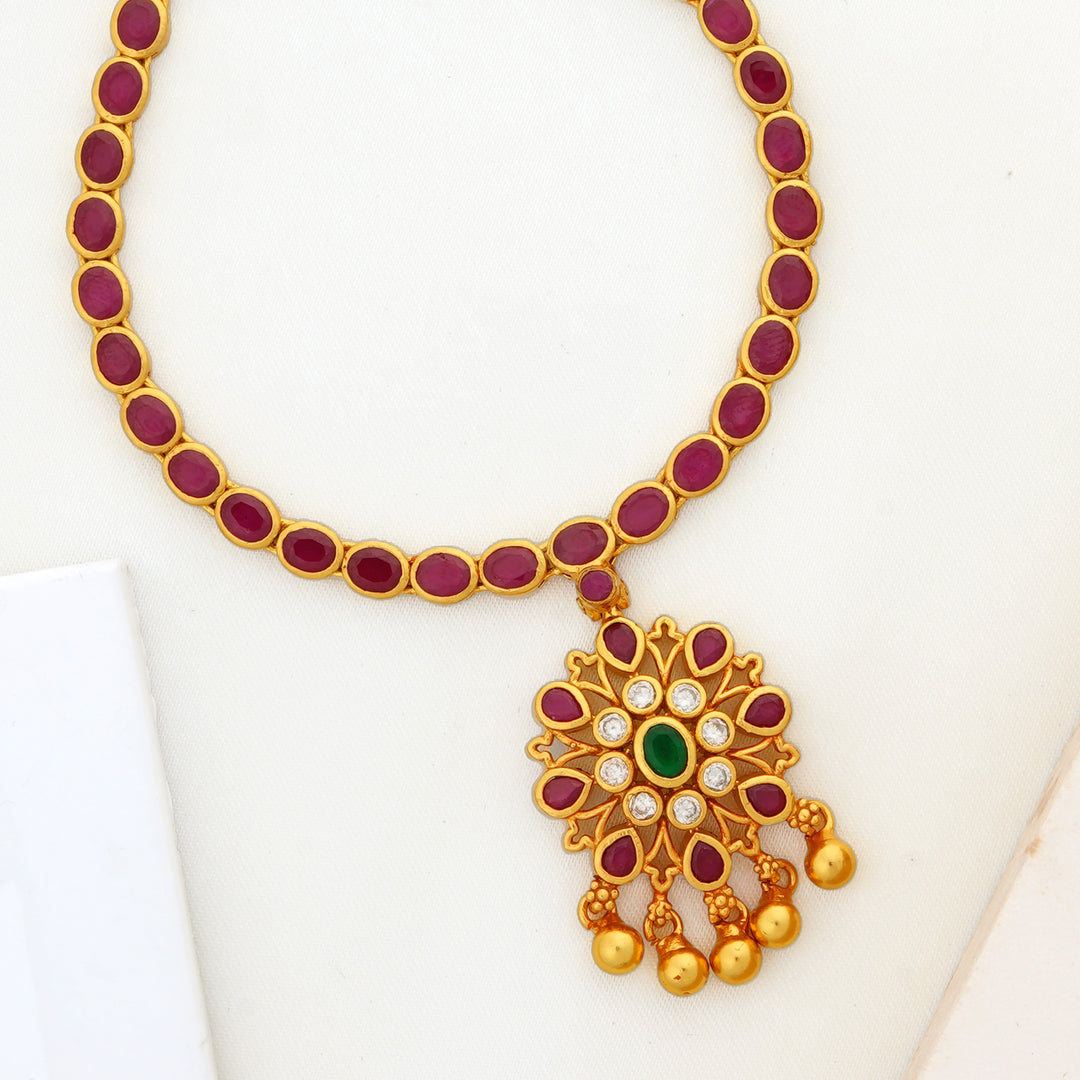 Gold-finish ruby necklace with temple-style pendant design