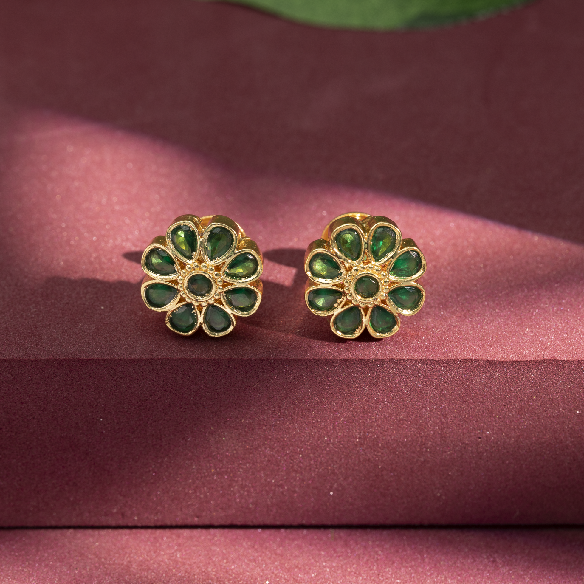 Gold plated green stone floral stud earrings