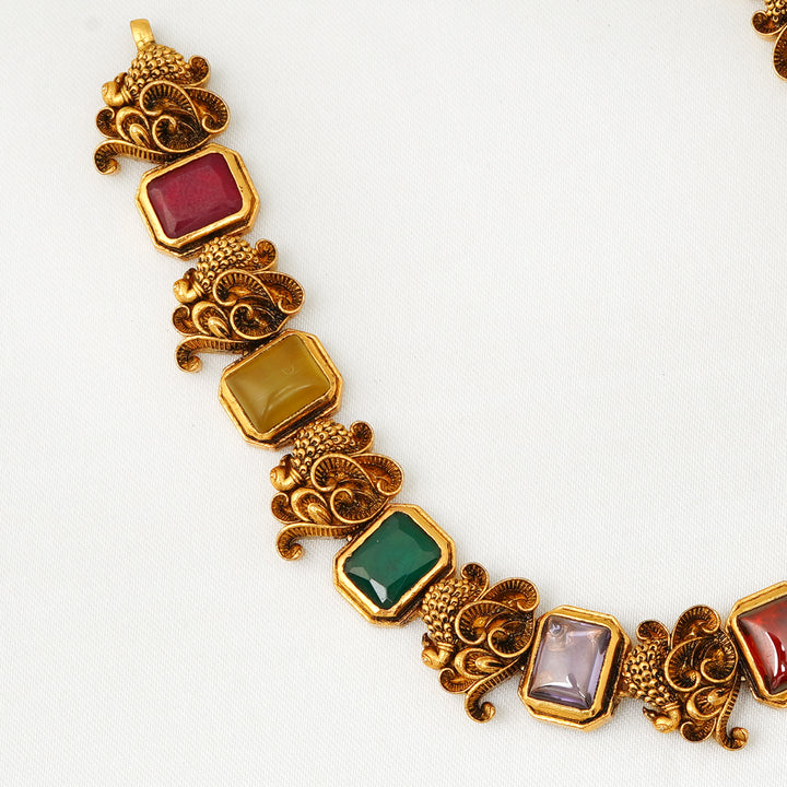 Handcrafted antique Navaratna necklace with symbolic peacock elements for traditional occasions