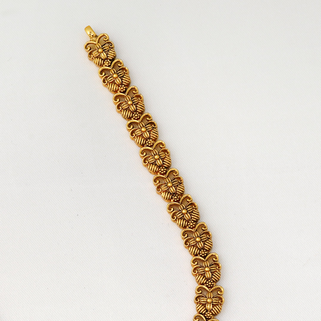 Handcrafted antique finish necklace with peacock motifs and emerald center stone