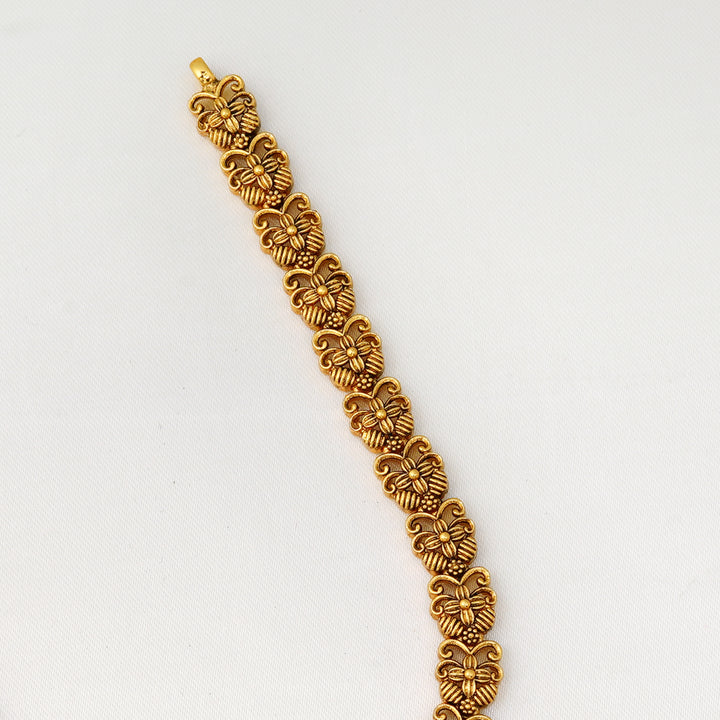 Handcrafted antique finish necklace with peacock motifs and emerald center stone