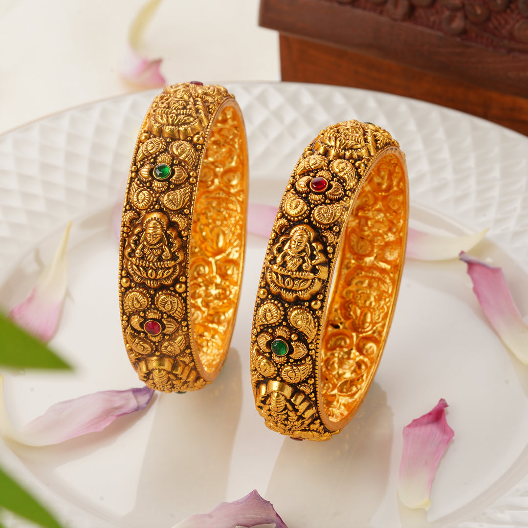 Lakshmi and mango design gold bangles with ruby and emerald stones 