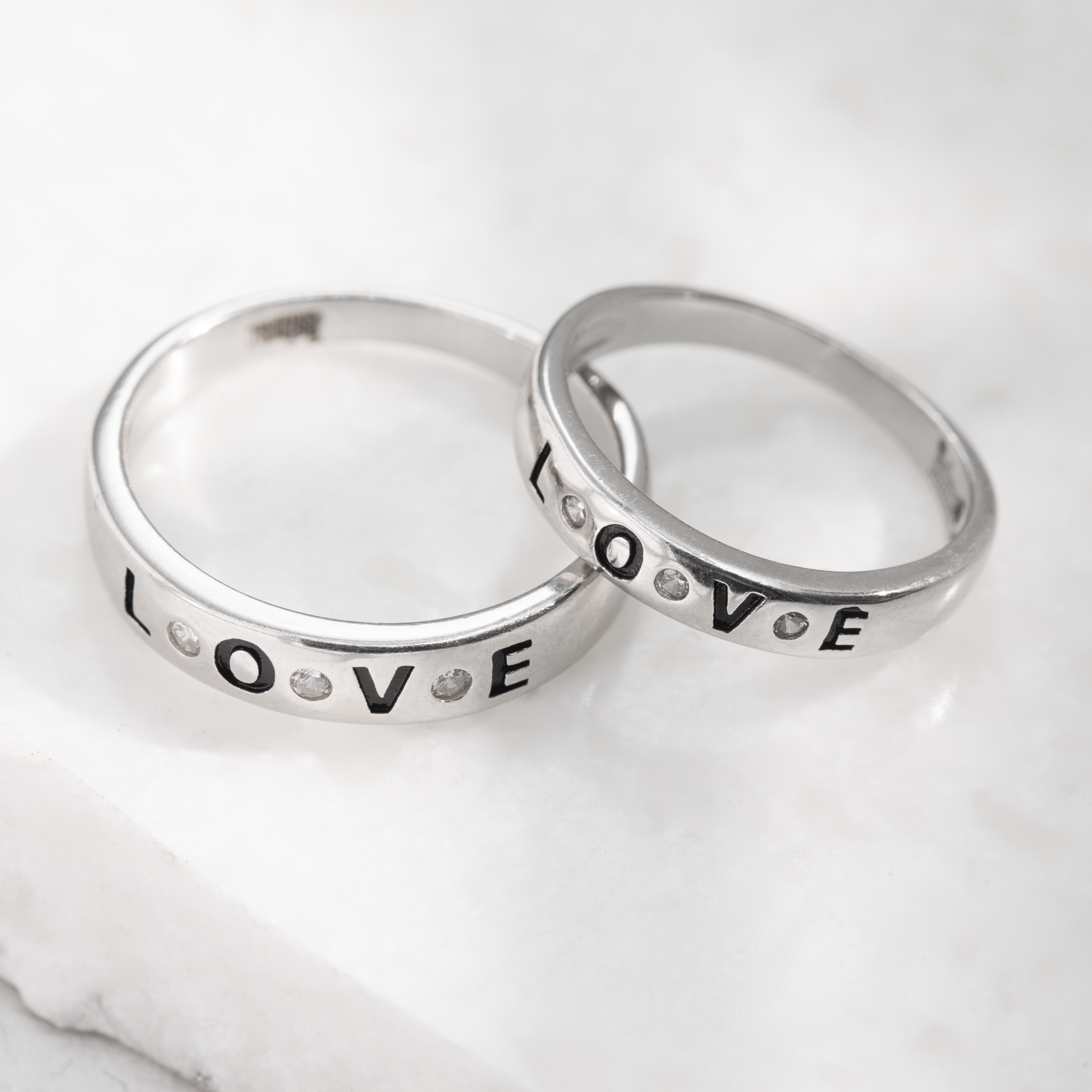Matching silver Love rings for couples