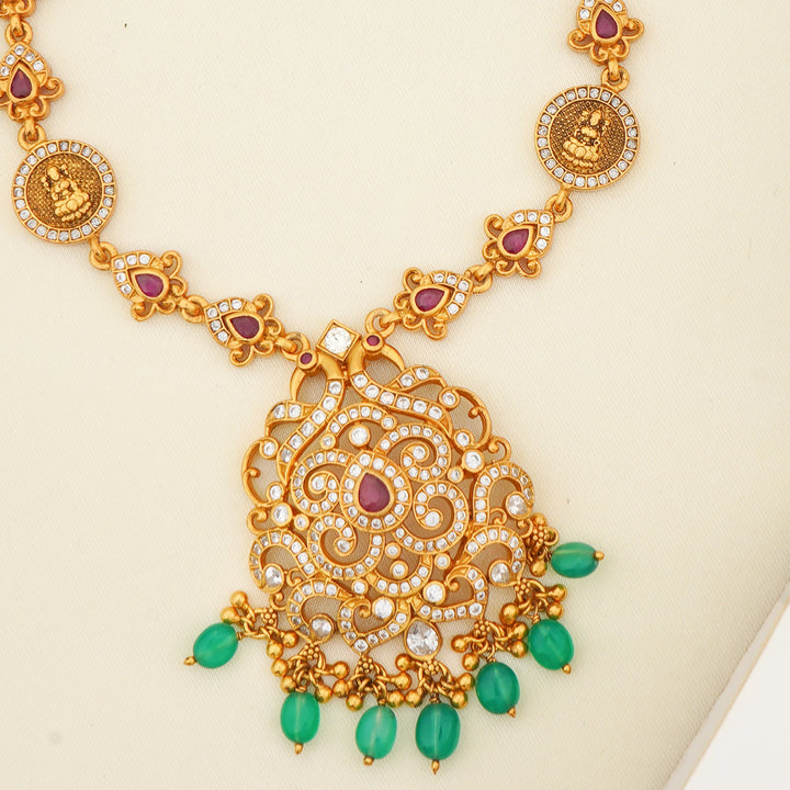 Mid-length ruby and emerald haram with CZ studded floral pendant