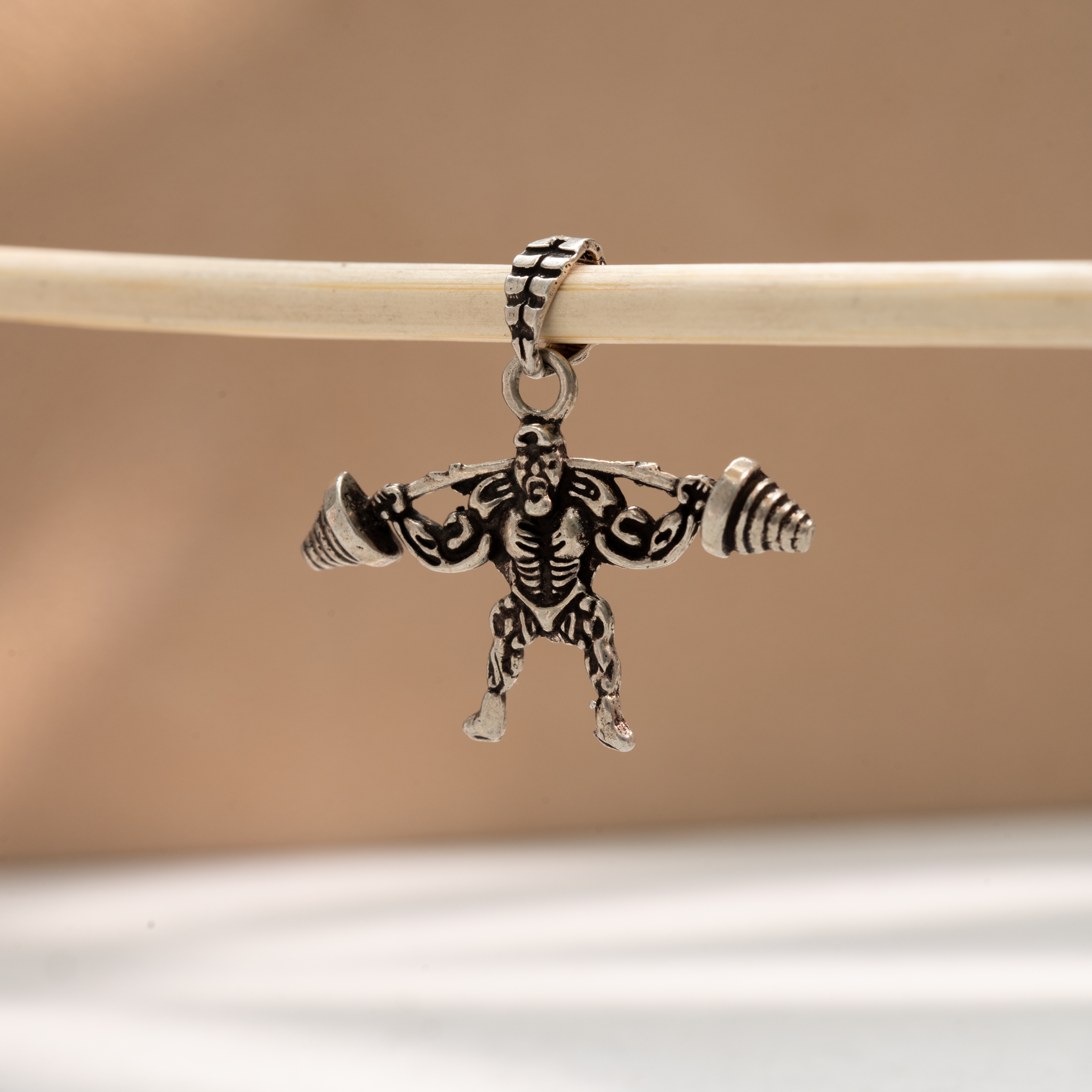 Muscular weightlifter barbell pendant
