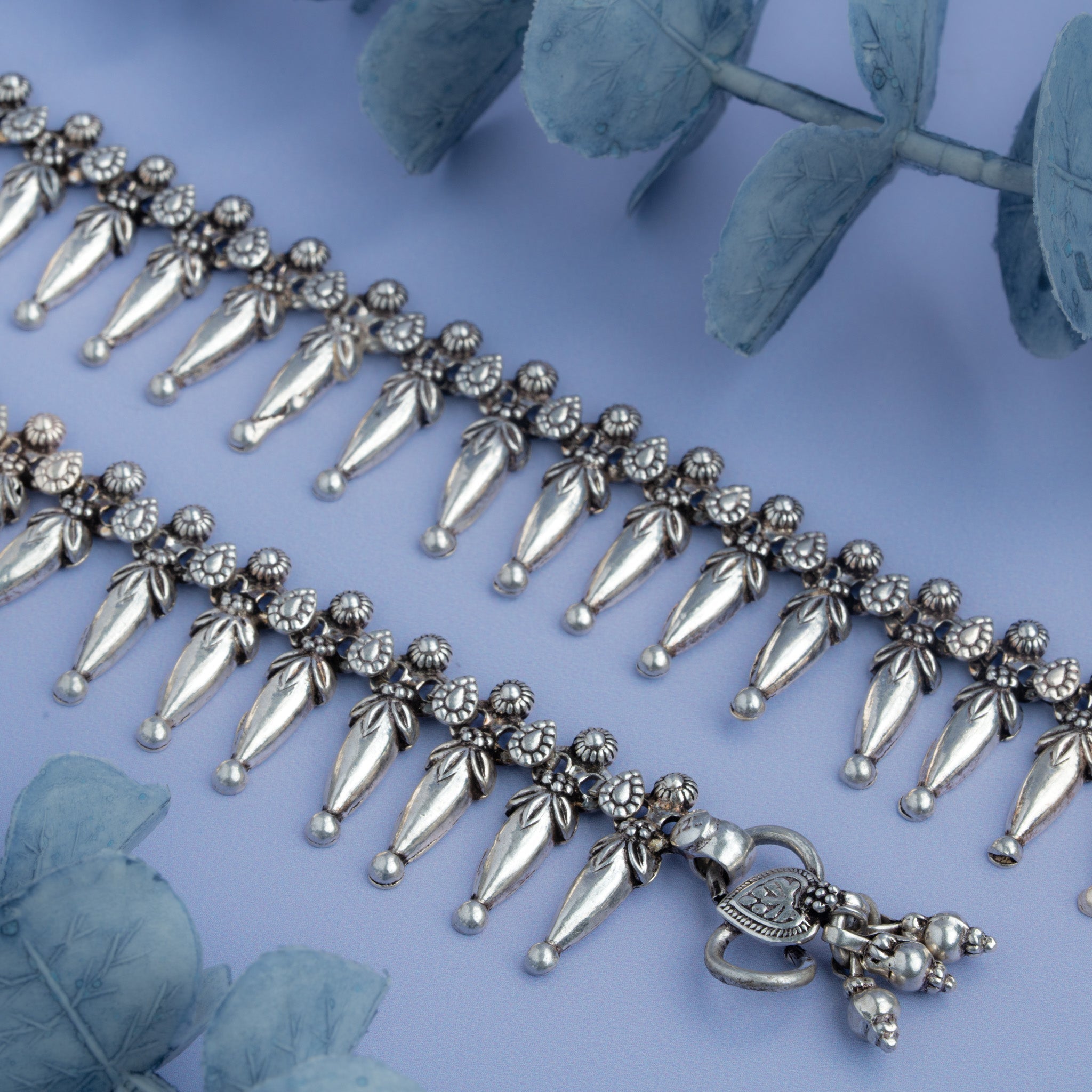 Oxidized silver anklet featuring dangling charms