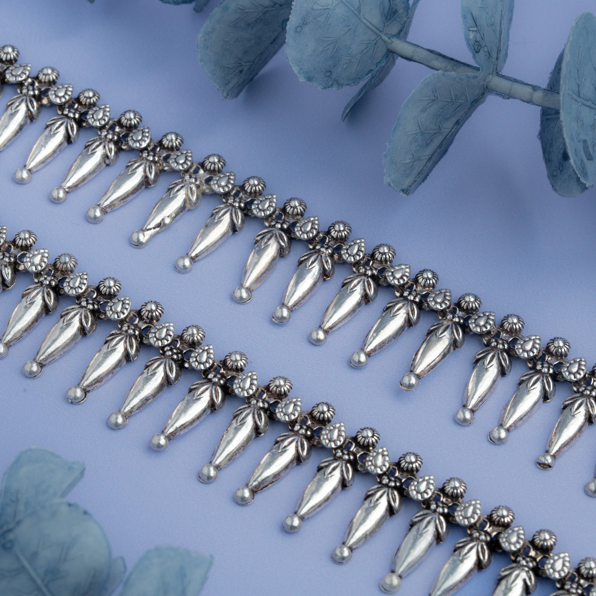 Oxidized silver anklet featuring mango-shaped dangling charms