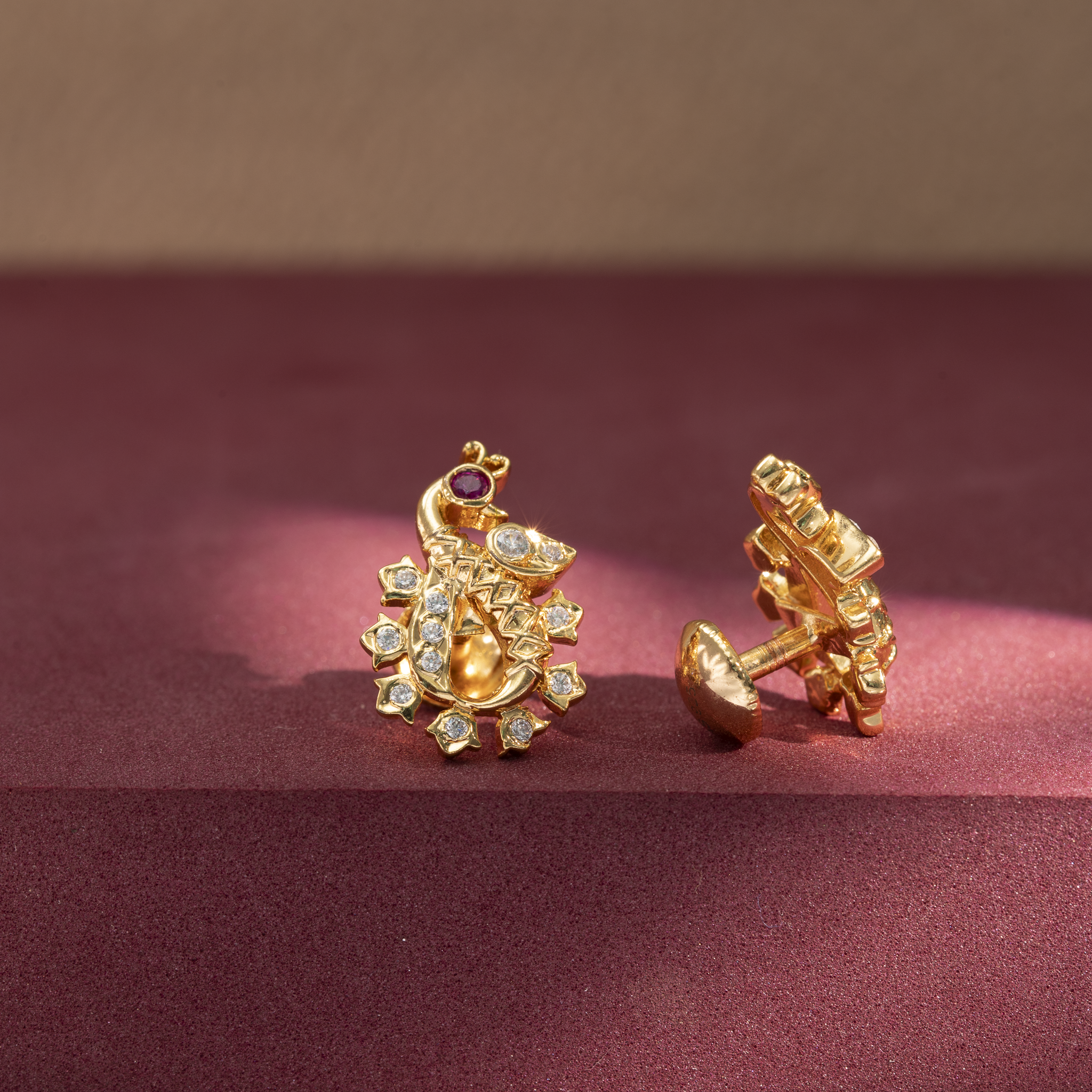 Peacock design gold earrings with ruby stones
