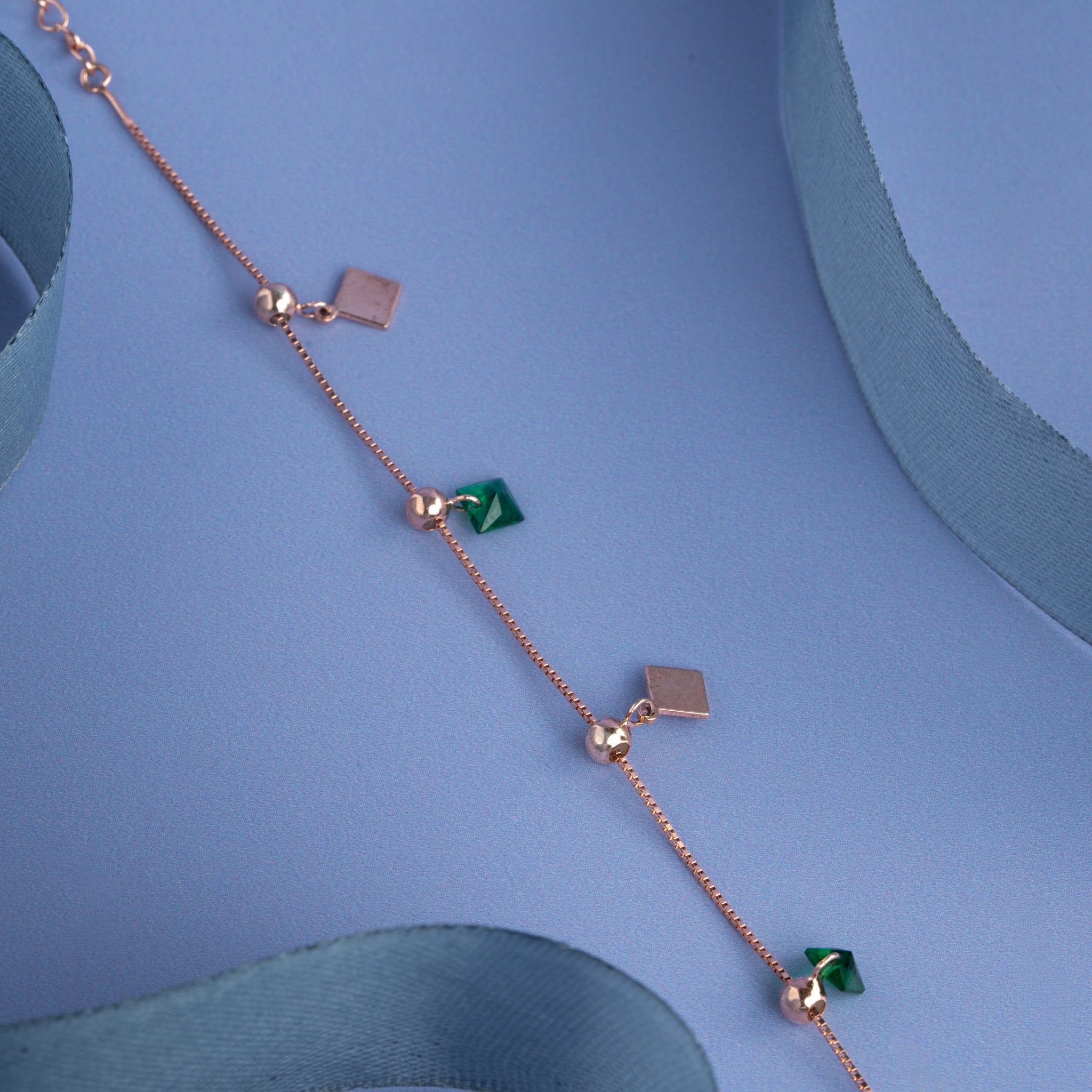 Rose gold bracelet with green geometric stone charms