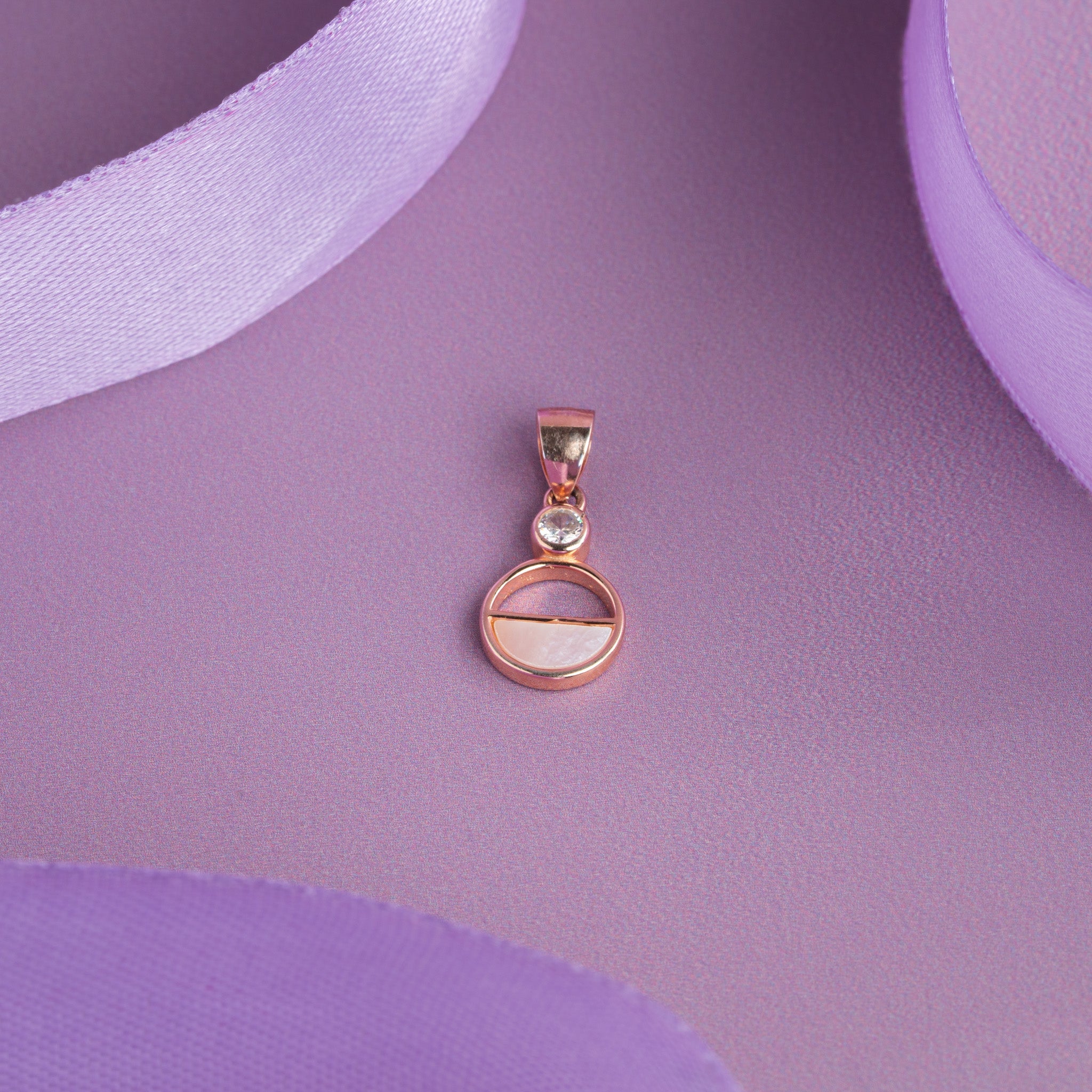 Rose gold round pendant with blue stone