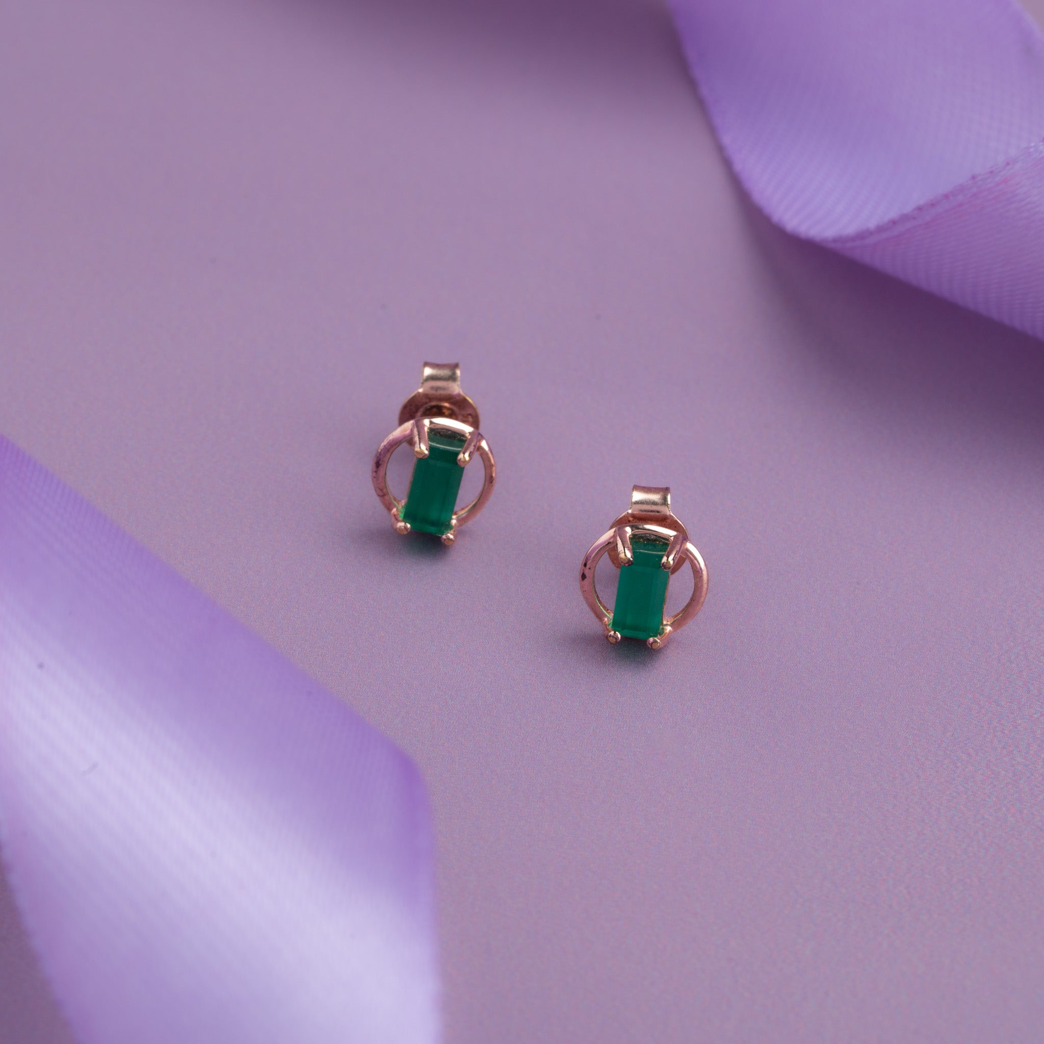 Rose gold stud with emerald green stone