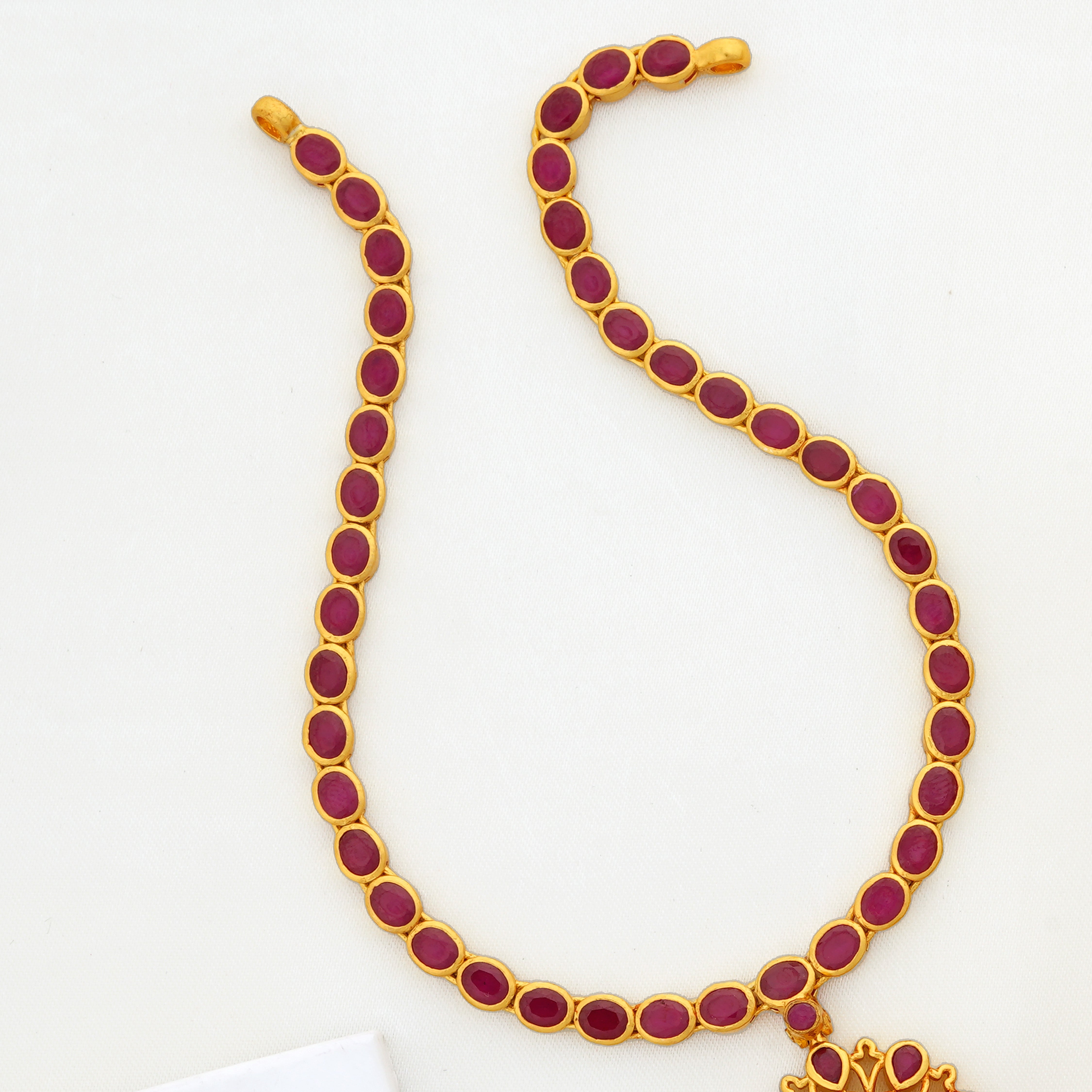 Ruby oval stone necklace with hanging gold beads
