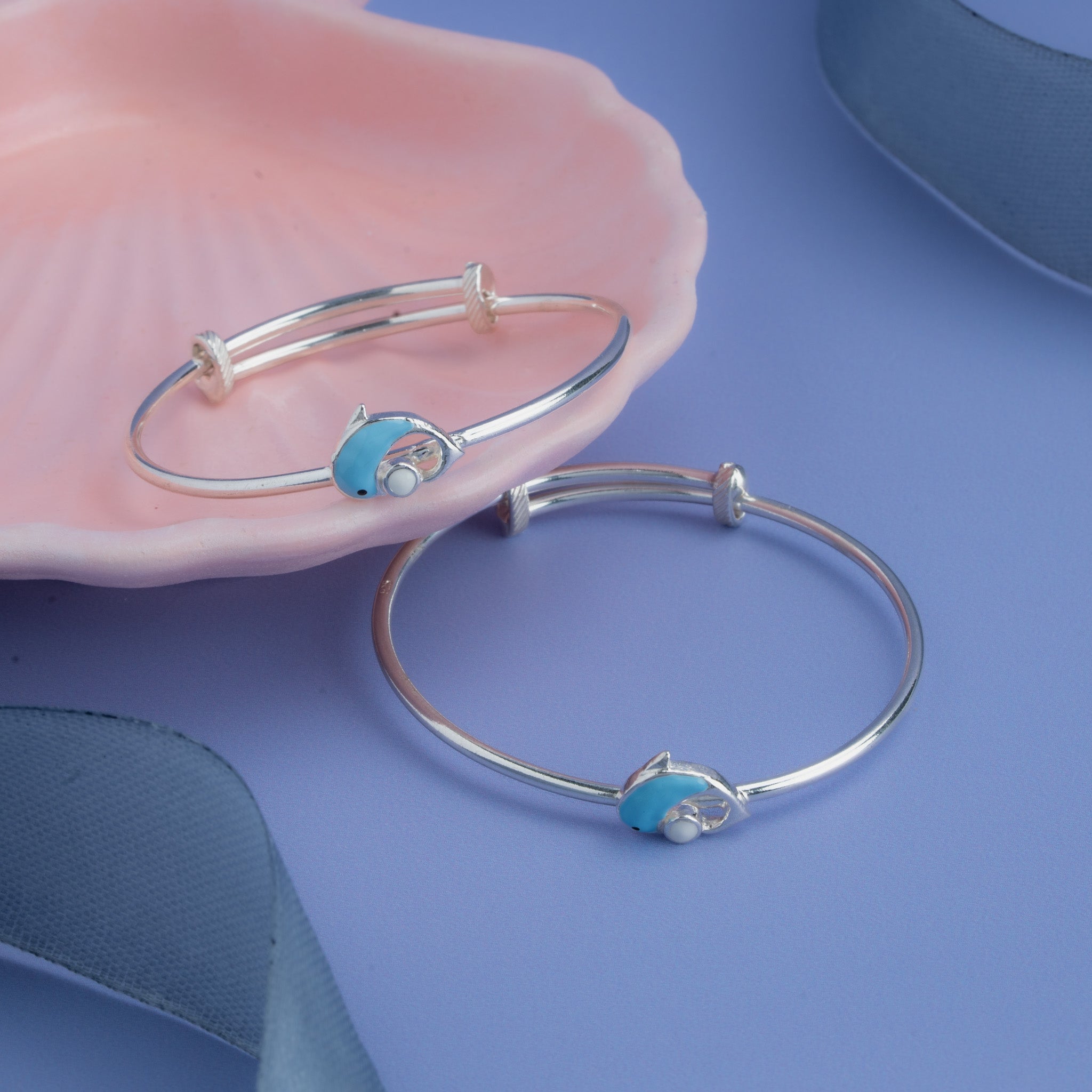 Silver baby bangle with blue dolphin charm