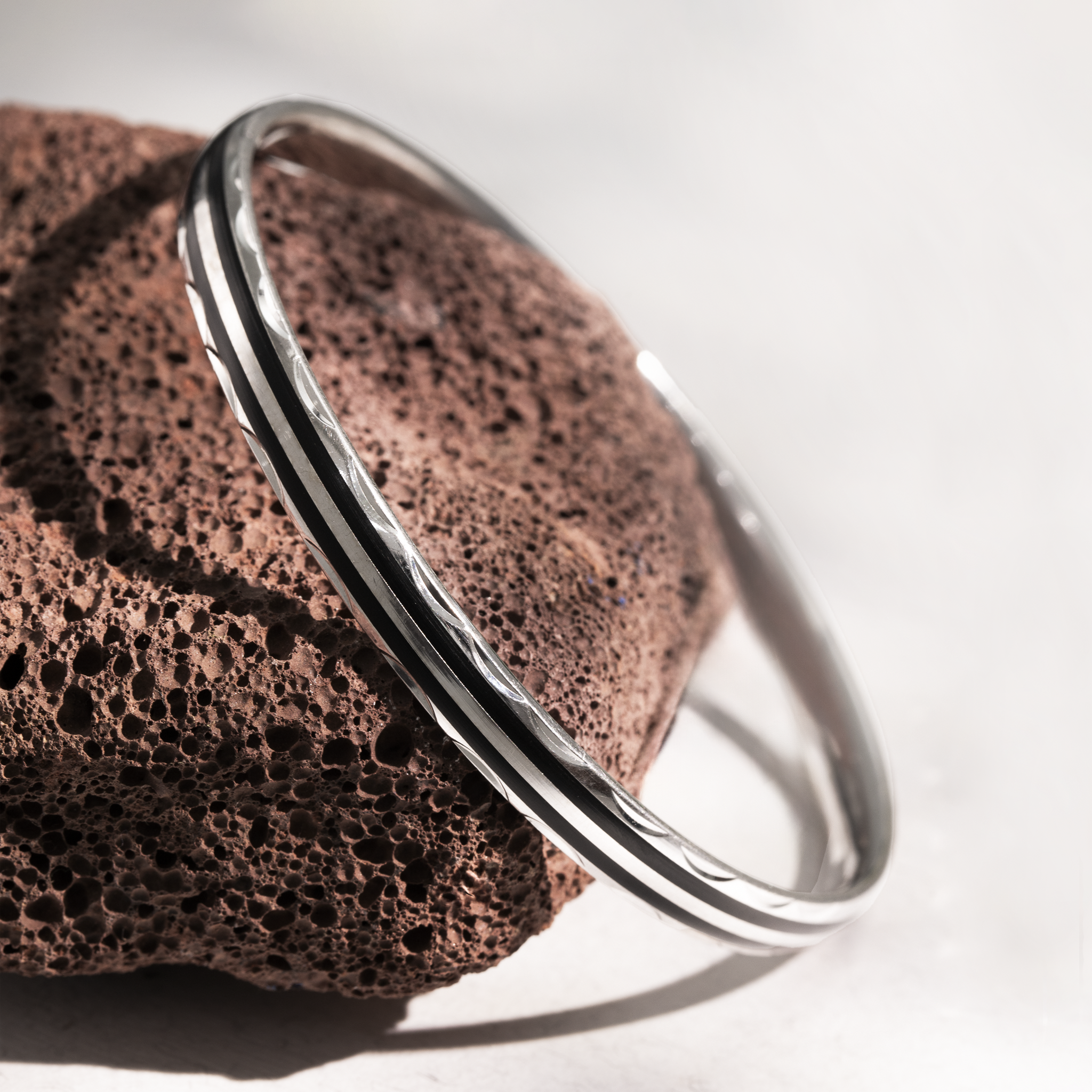 Silver bangle with black enamel stripe