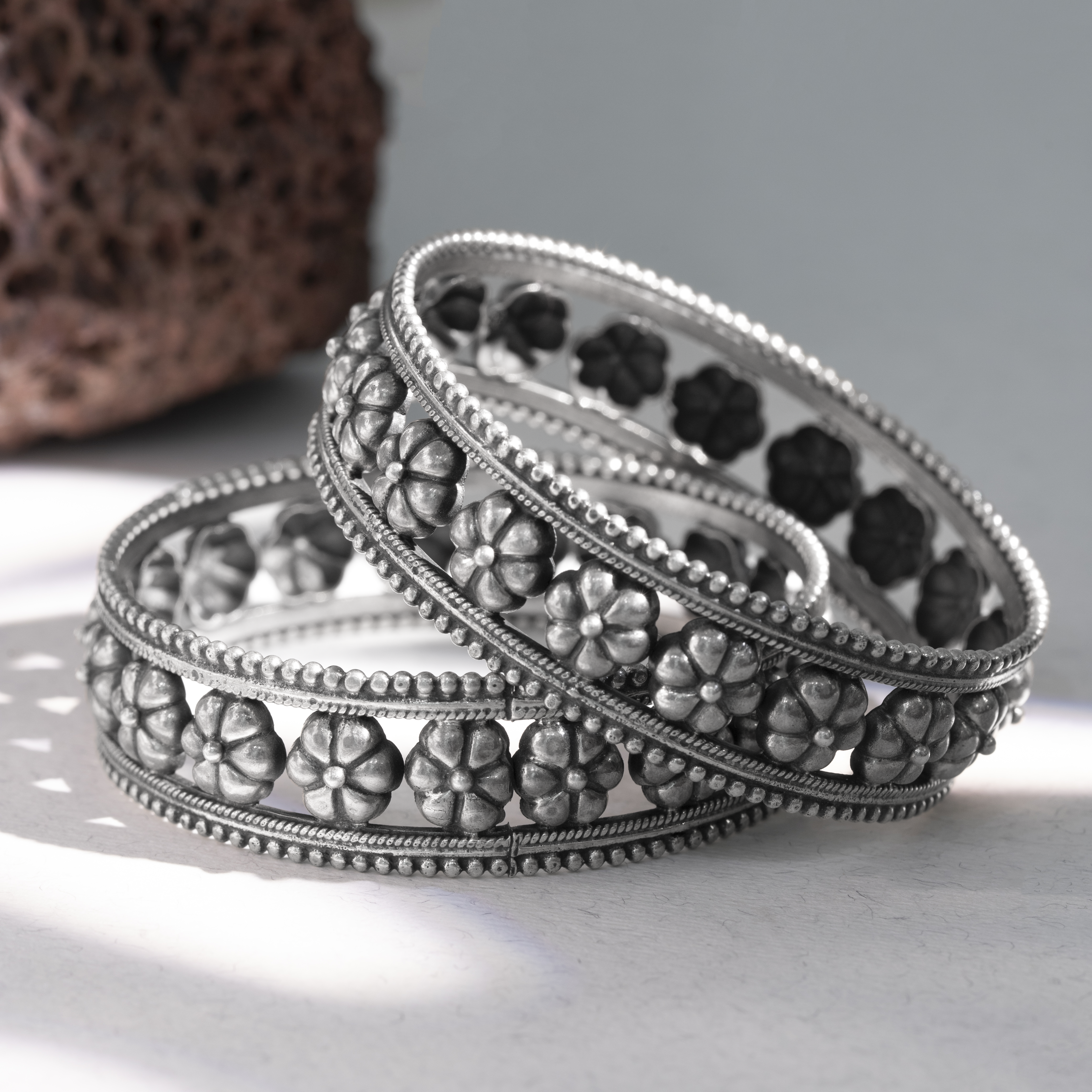 Silver bangles with raised flower design