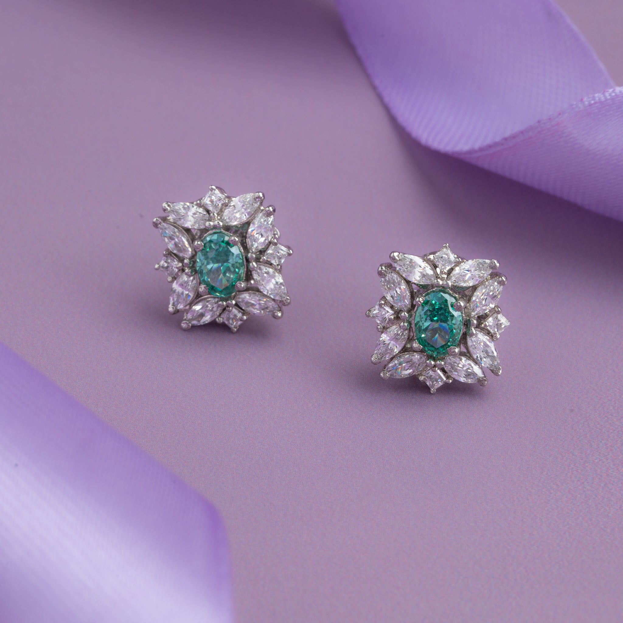 Silver floral stud earrings with emerald green