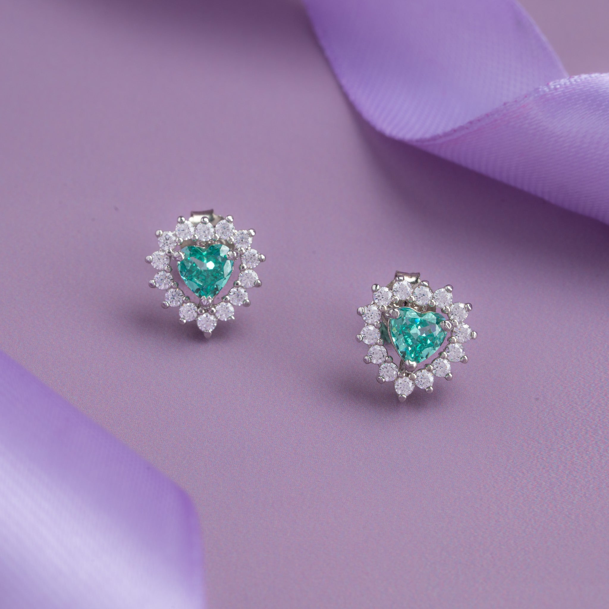 Silver heart-shaped blue stone stud