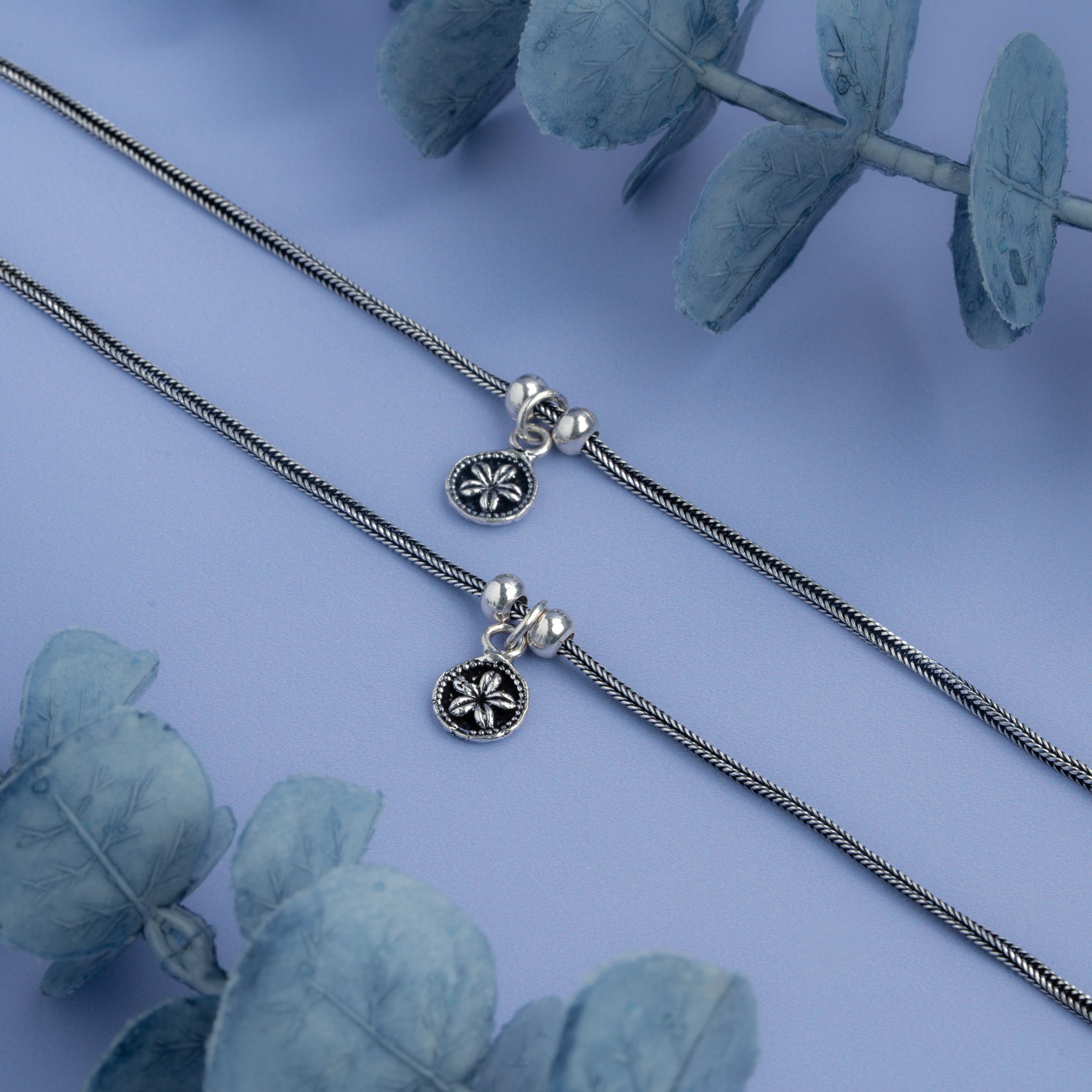 Silver snake chain anklet with floral coin charm and adjustable slider clasp