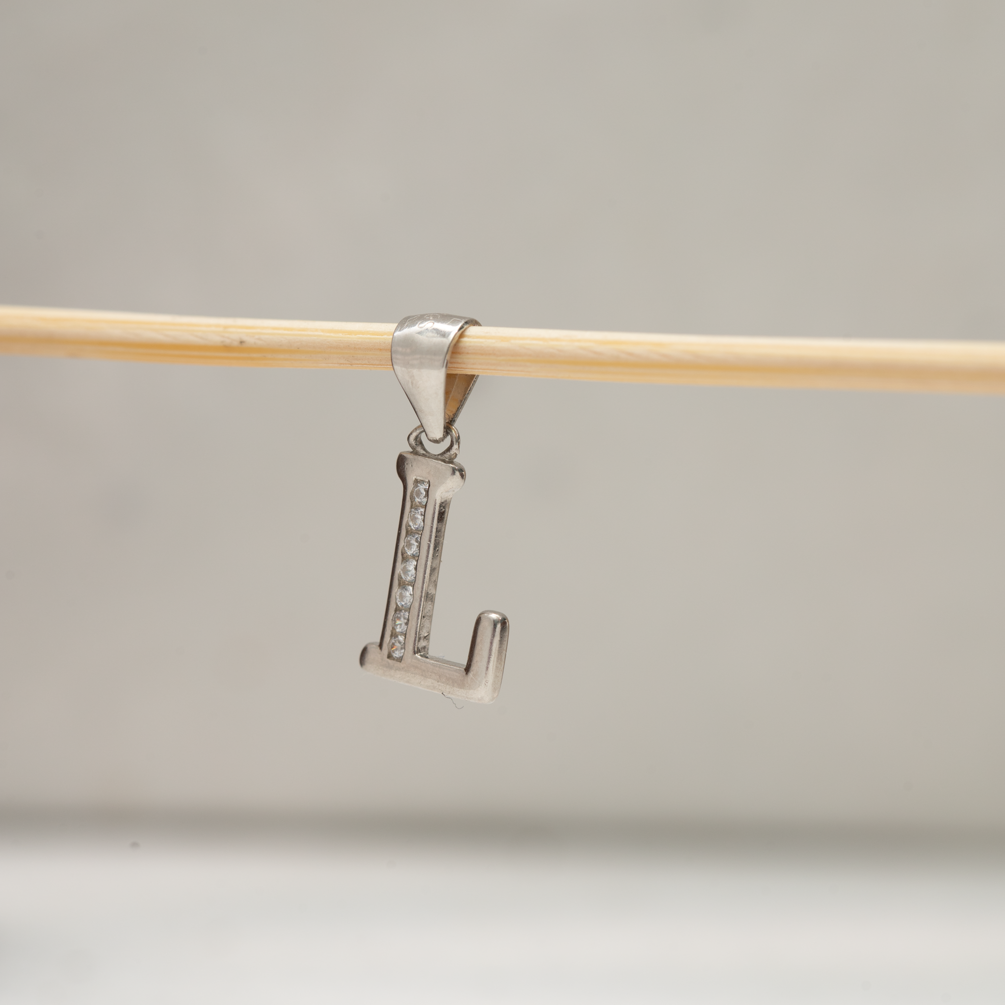 Stone studded alphabet L silver pendant