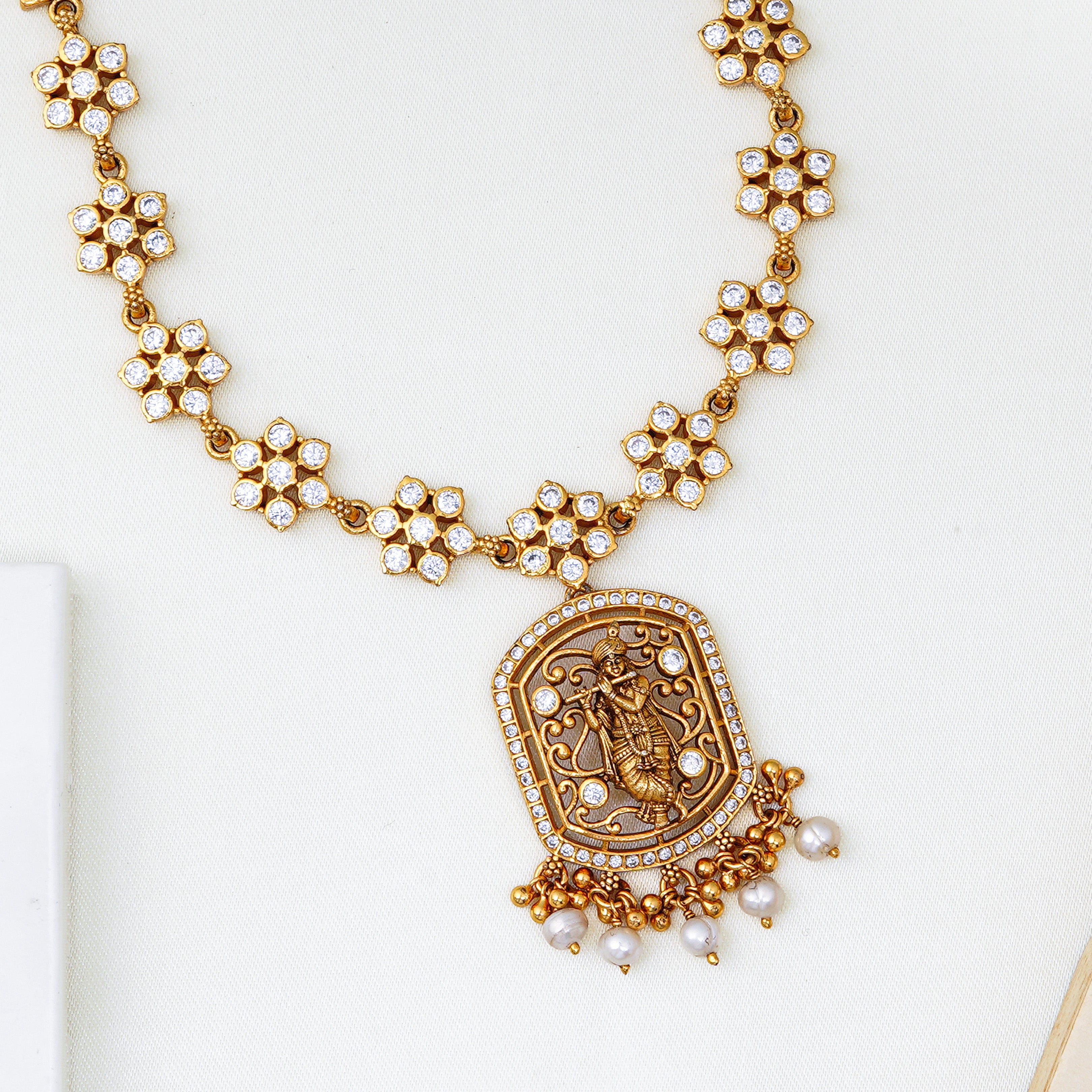 Temple jewellery style gold necklace with engraved pendant and Swarovski crystals