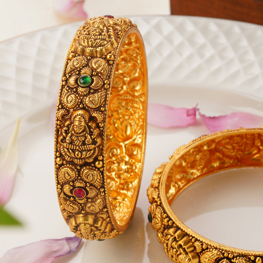 Traditional antique gold bangles with Lakshmi motifs and gemstone work