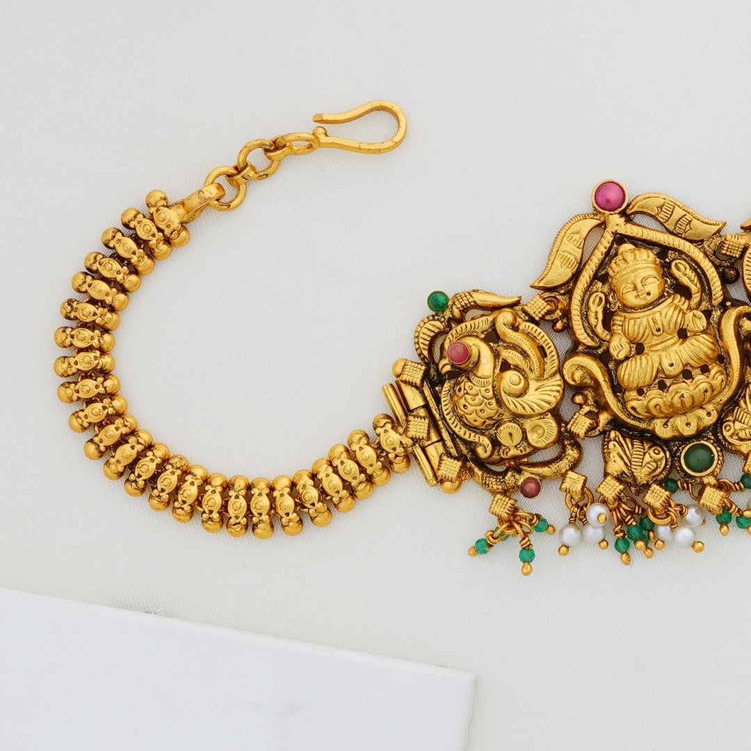 Traditional gold choker with temple design and peacocks