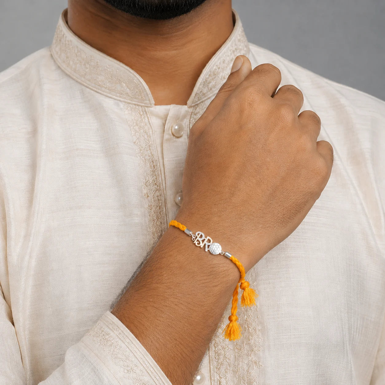 Silver Rakhi with Orange Thread