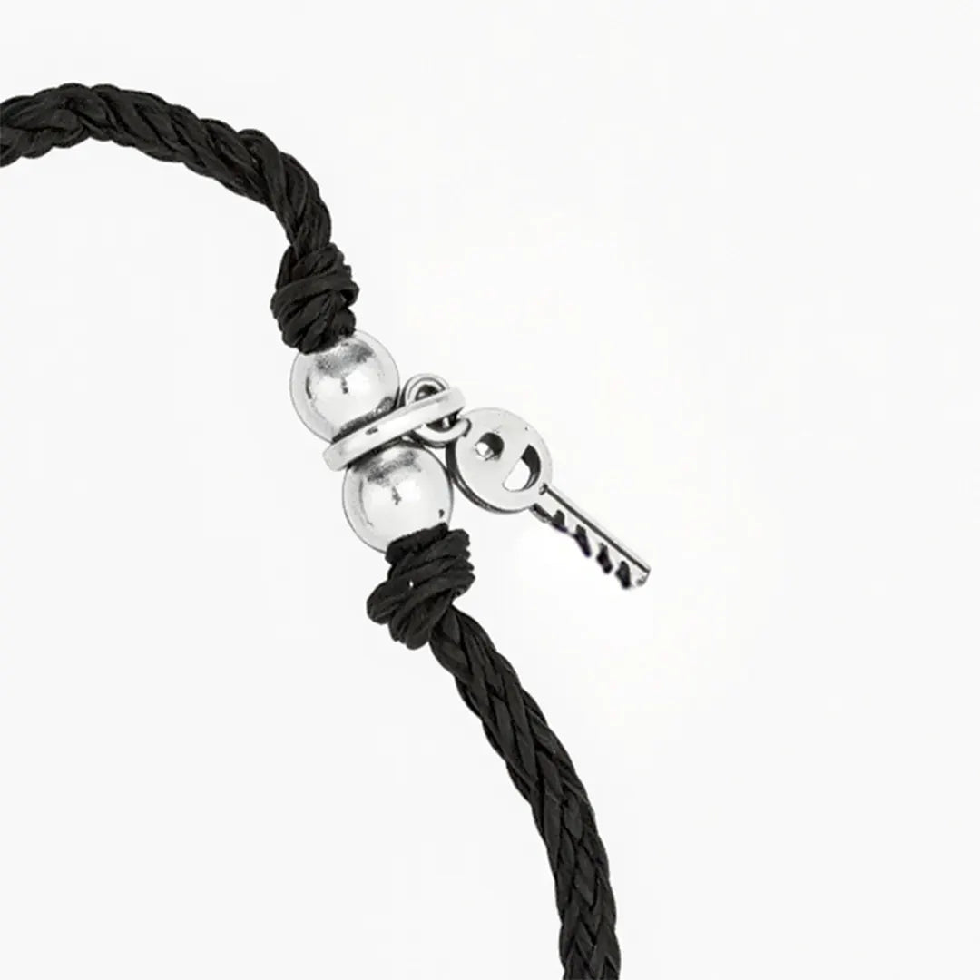 black thread bracelet with silver key charm
