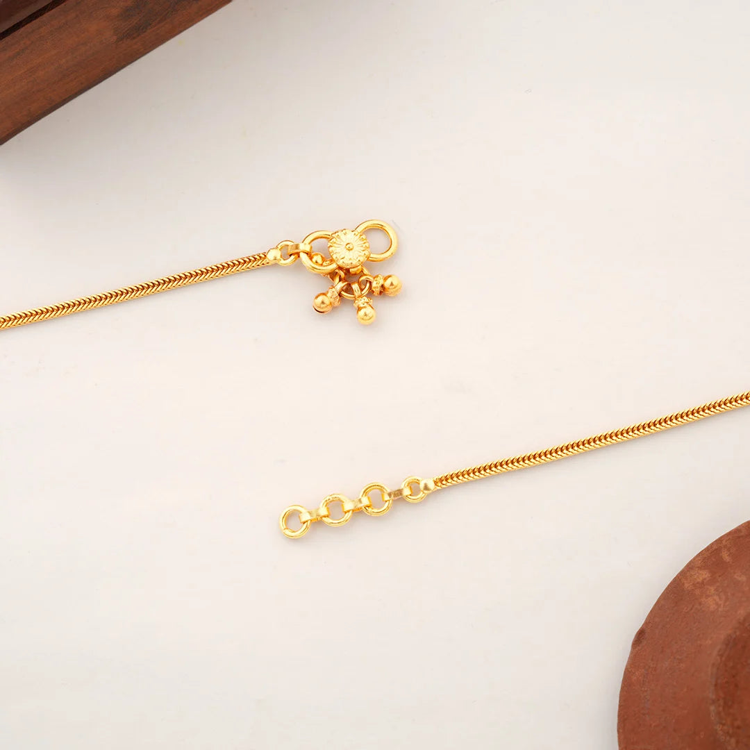 gold anklet with floral design