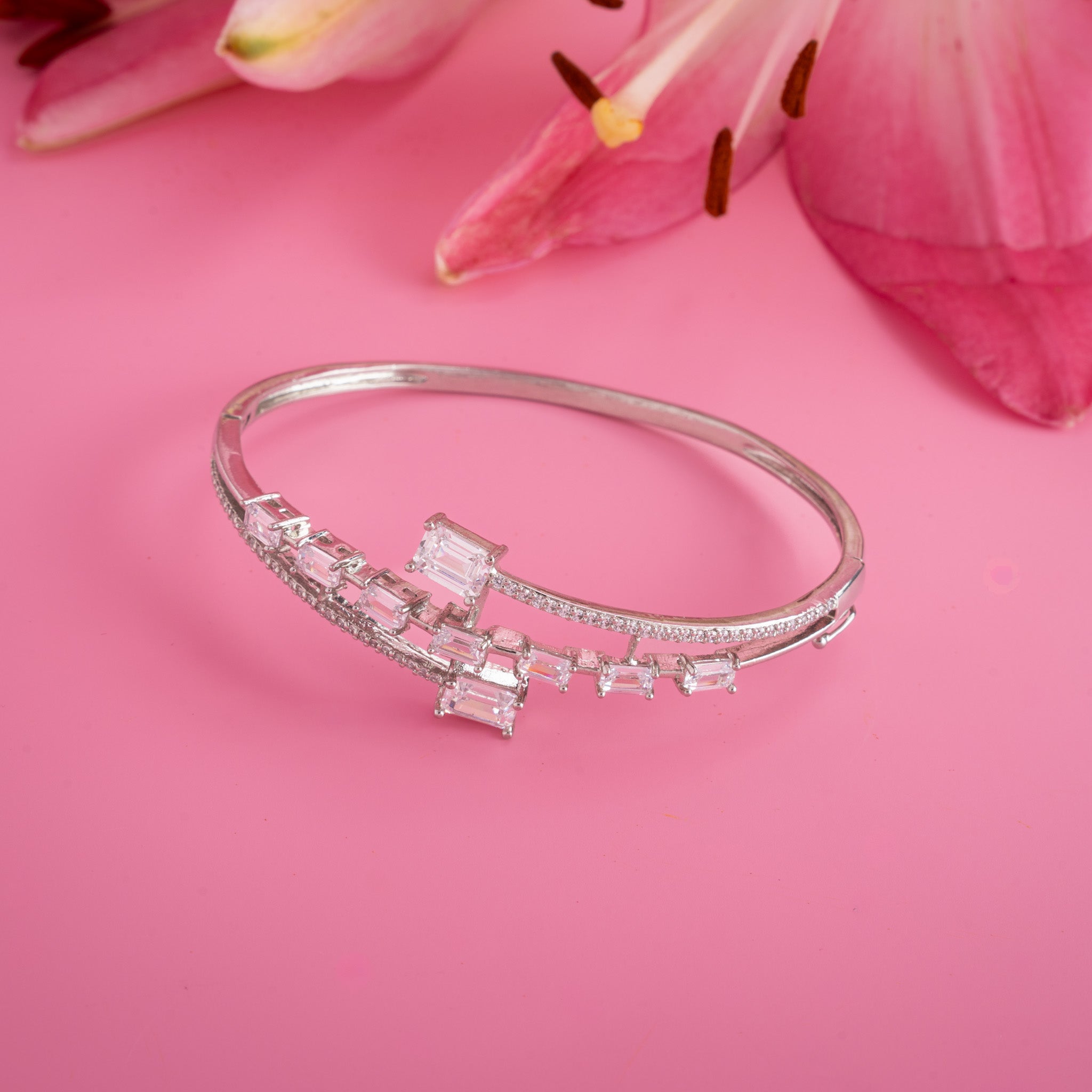 silver bangle with emerald cut stones