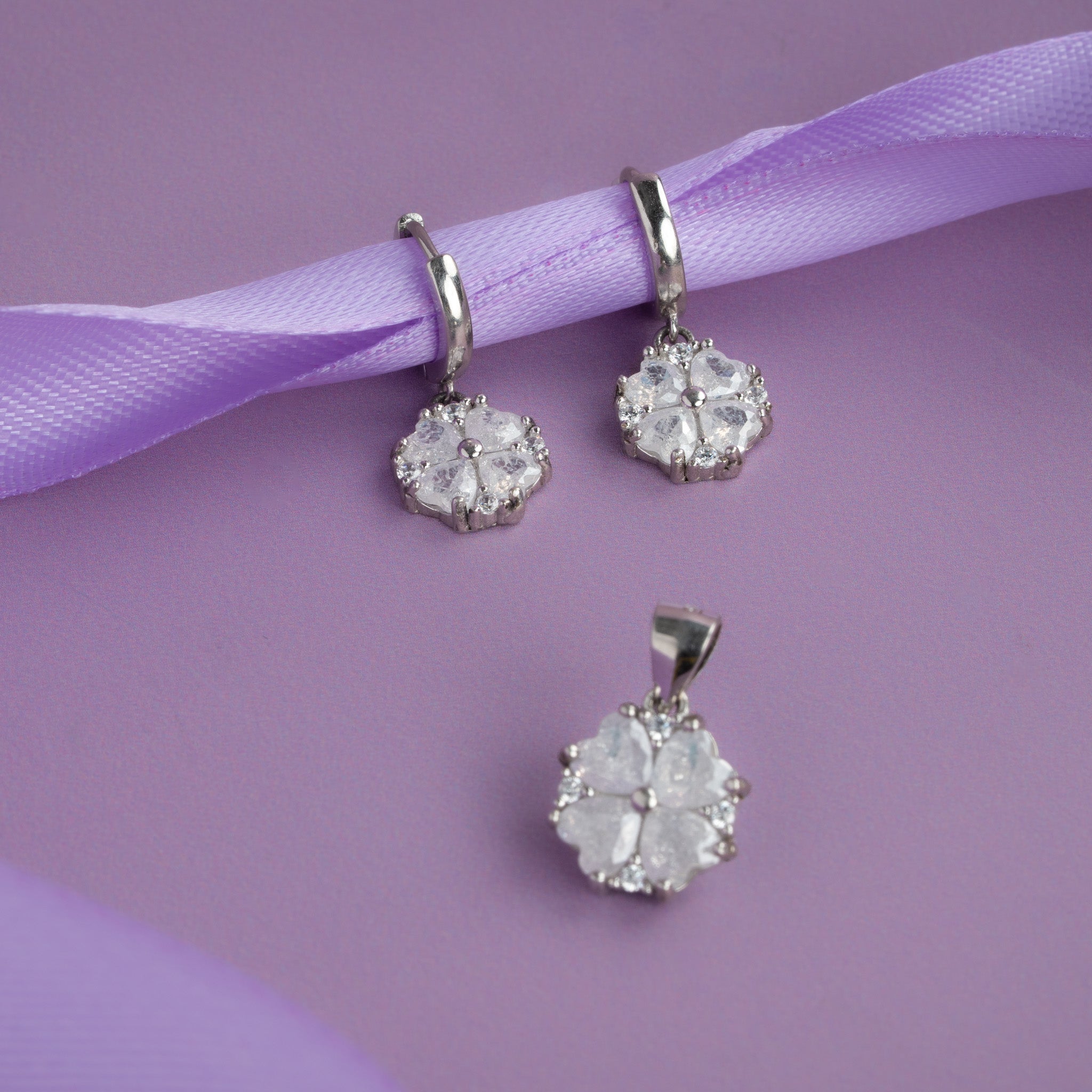 silver floral pendant with white stones